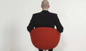 Businessman sitting in modern office chair --- Image by © Klaus Tiedge/Corbis